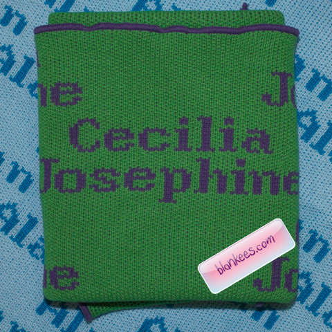 Personalized baby blanket knit with baby's names in purple on a lime green baby blanket.