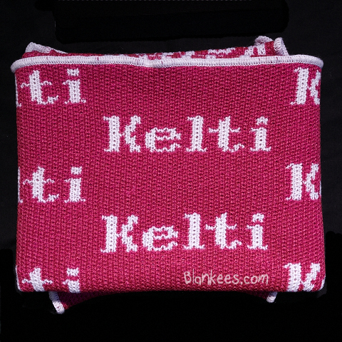 Personalized baby blanket. Fuchsia blanket with name knit in white for the personalization.